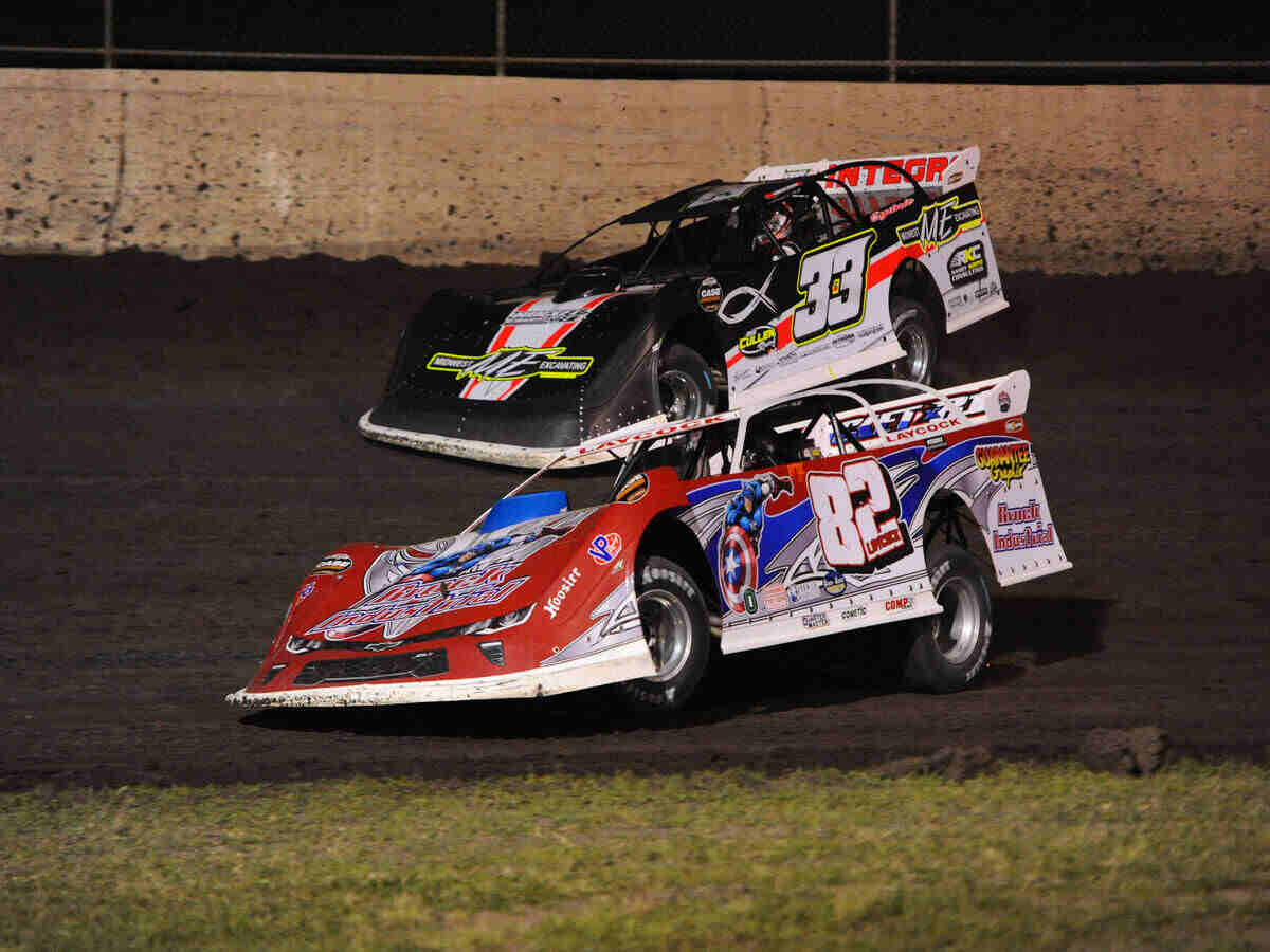 Billy Laycock (82) Chevrolet Camaro races Tony Jackson Jr (33) Bob Cullen Racing Chevrolet SS through turn three in the second World of Outlaws (WoO) Case Construction Late Models qualifying heat at the World Wide Technology Raceway