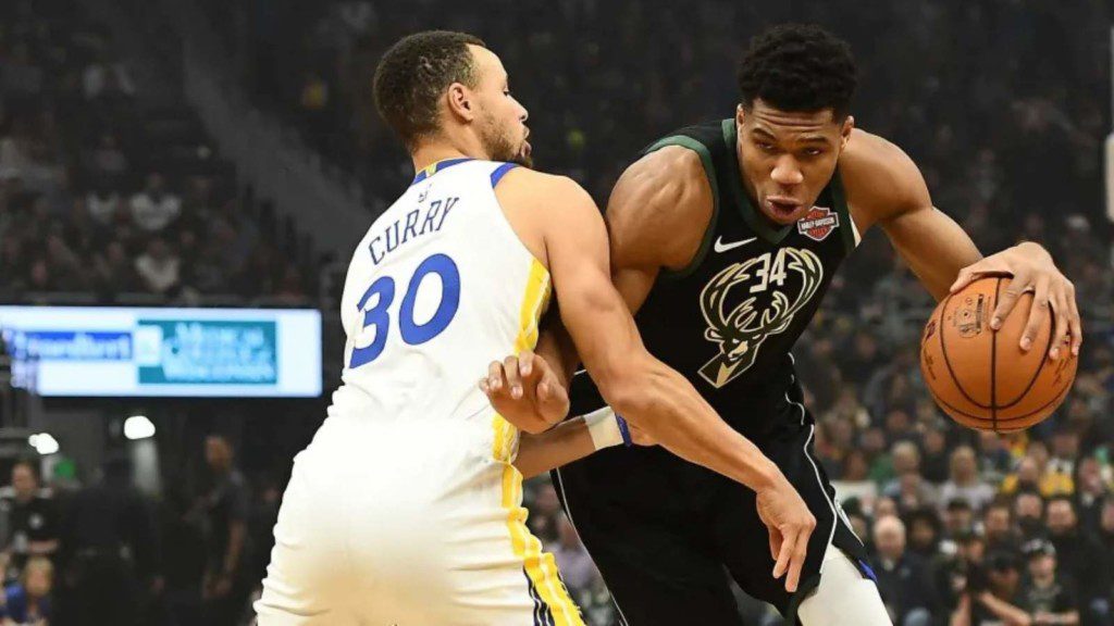 Giannis Antetokounmpo and Stephen Curry in action