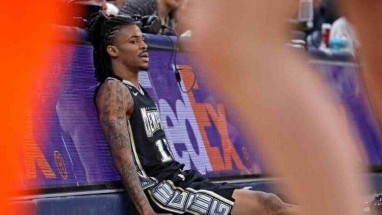 Ja Morant sitting on the floor after suffering injury