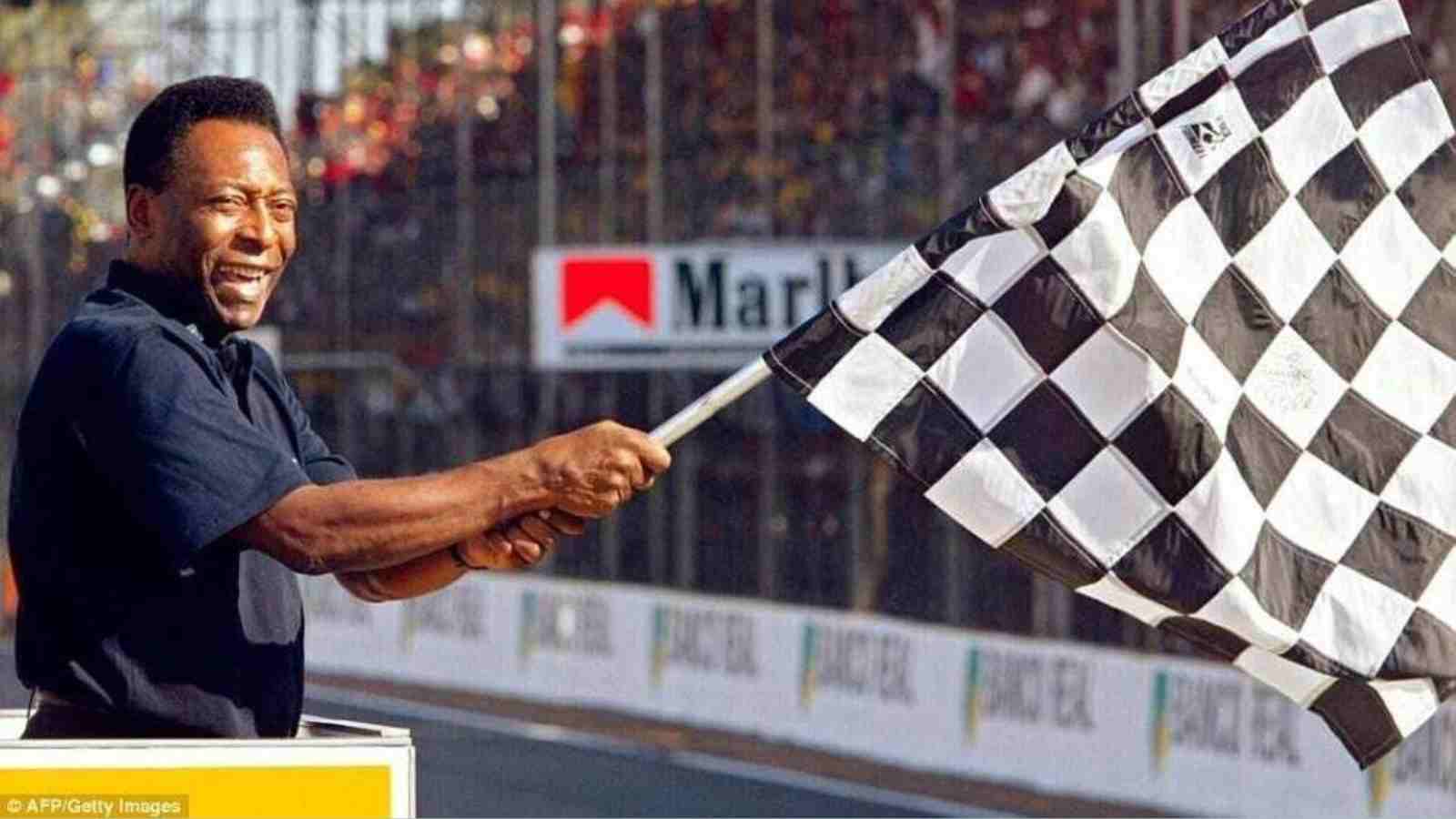 At which racer did the late Pele wave the chequered flag at the 2002 Brazilian GP after initially failing to do so?