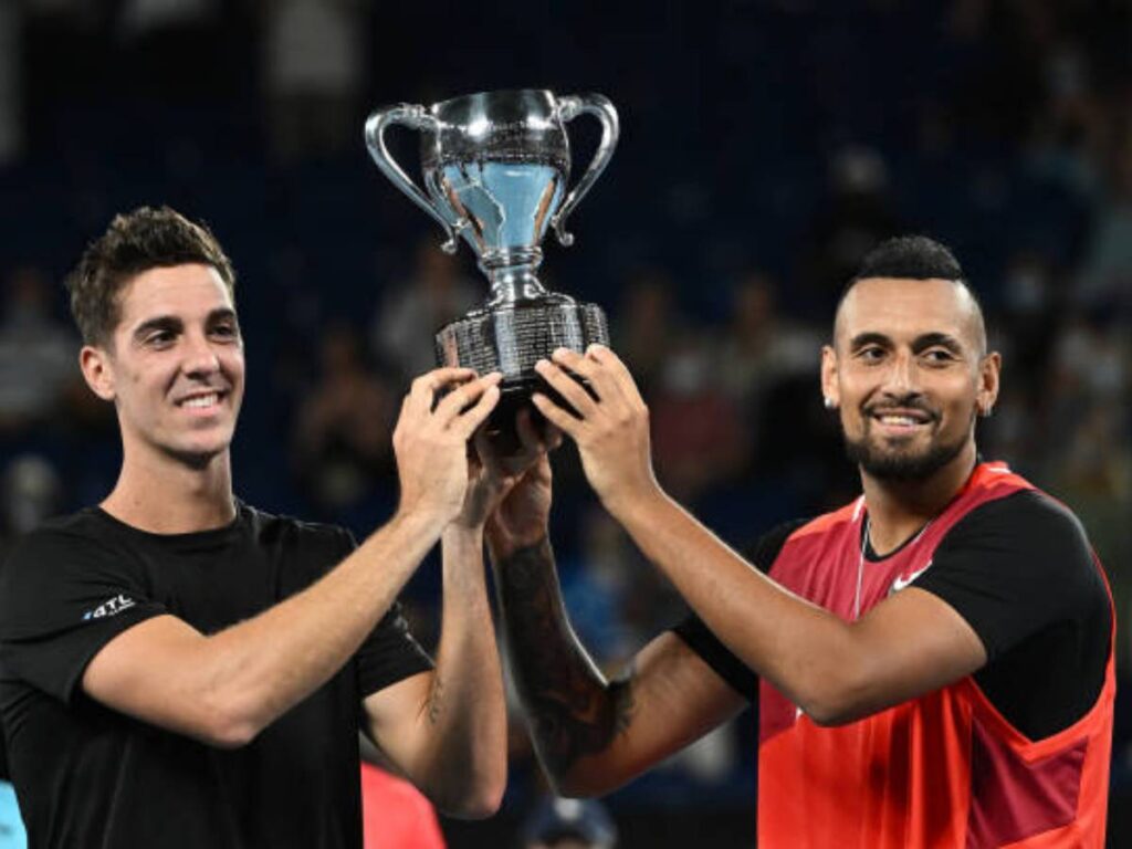 Thanasi Kokkinakis and Nick Kyrgios lifting the doubles 2022 Australian Open trophy