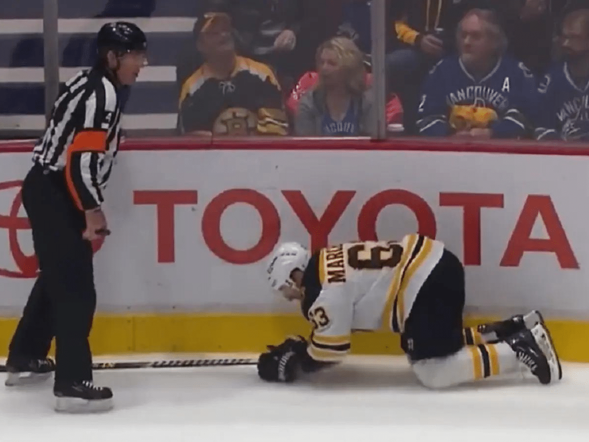 <strong>WATCH: Brad Marchand gets DEMOLISHED by NHL referee Wes McCauley following bizarre hit, NHL Twitter reacts</strong>