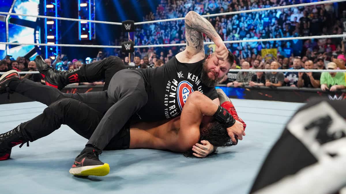 WATCH: Kevin Owens makes a grand return to save Sami Zayn from the jaws of Roman Reigns at the Elimination Chamber