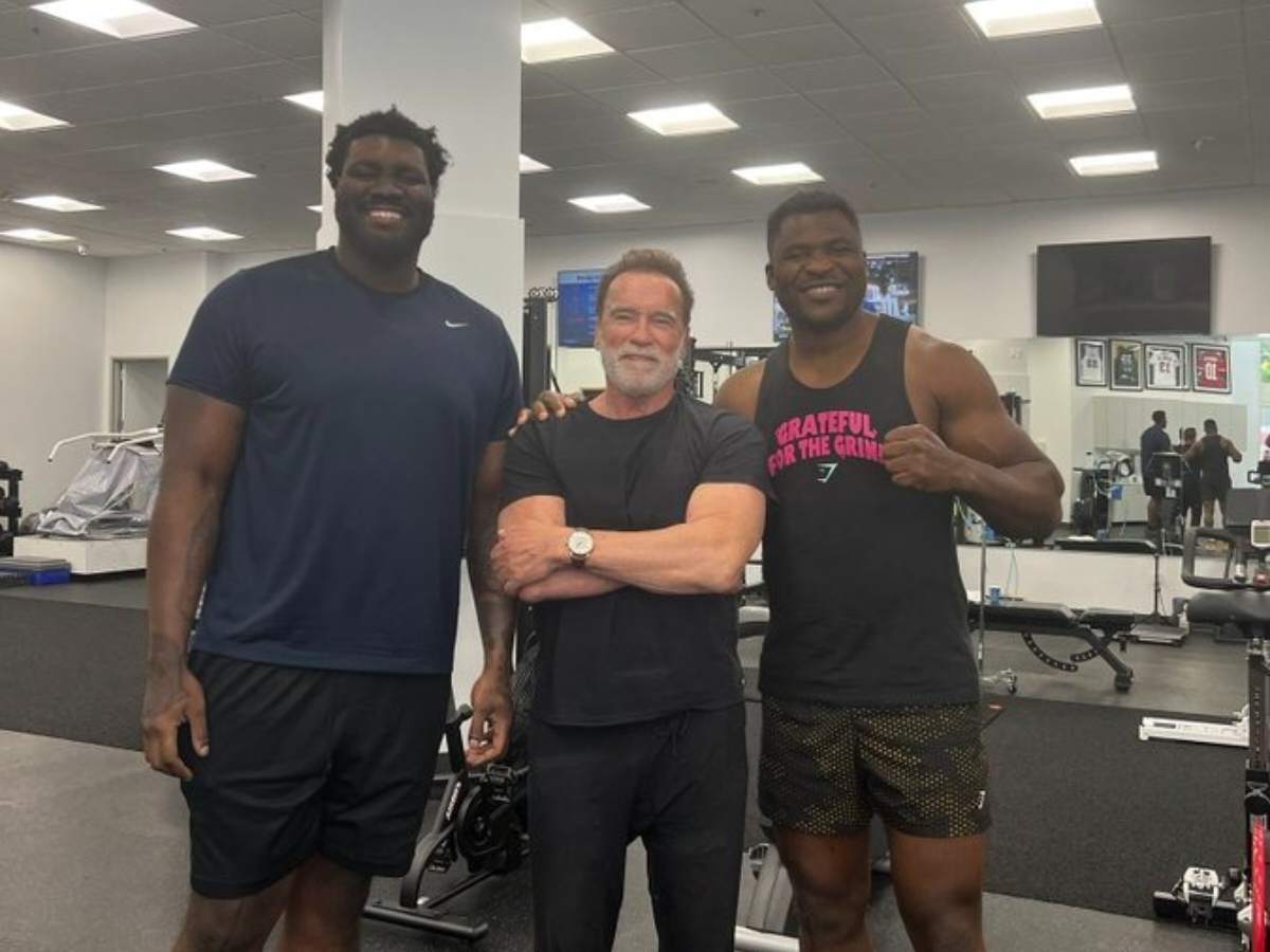 Legendary bodybuilder Arnold Schwarzenegger dwarfed as Francis Ngannou ...