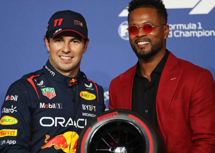 Sergio Perez (L) receives the pole position award for the F1 Saudi Arabian GP from Patrice Evra (R)