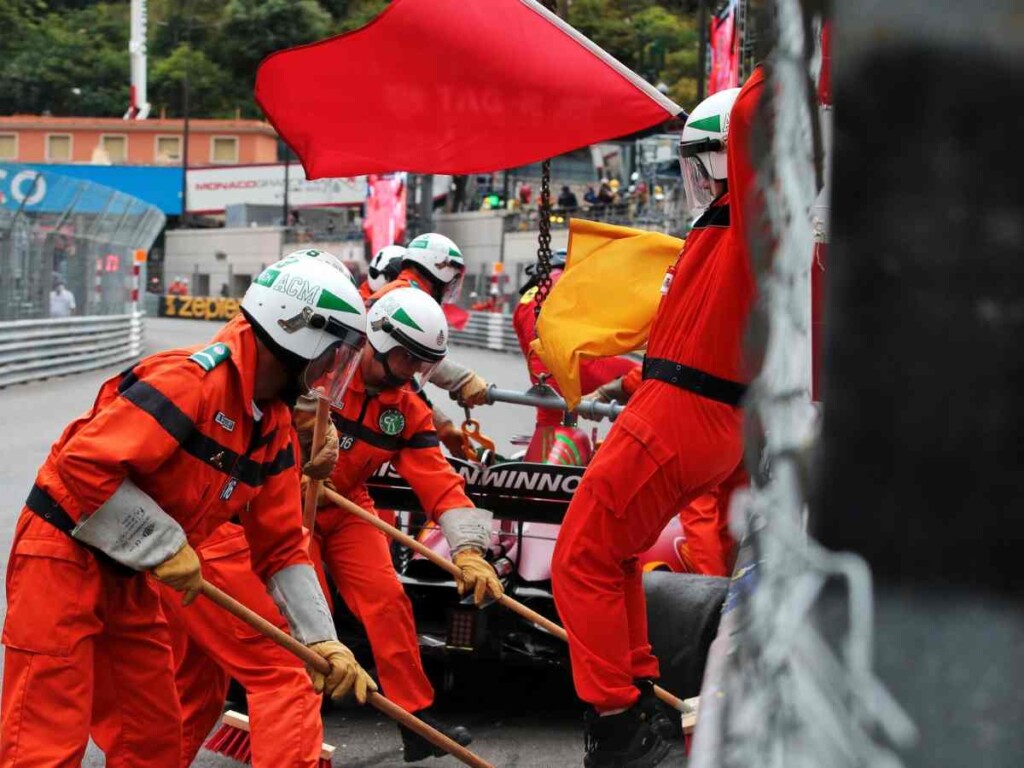 Marshalls waving red flag after a crash