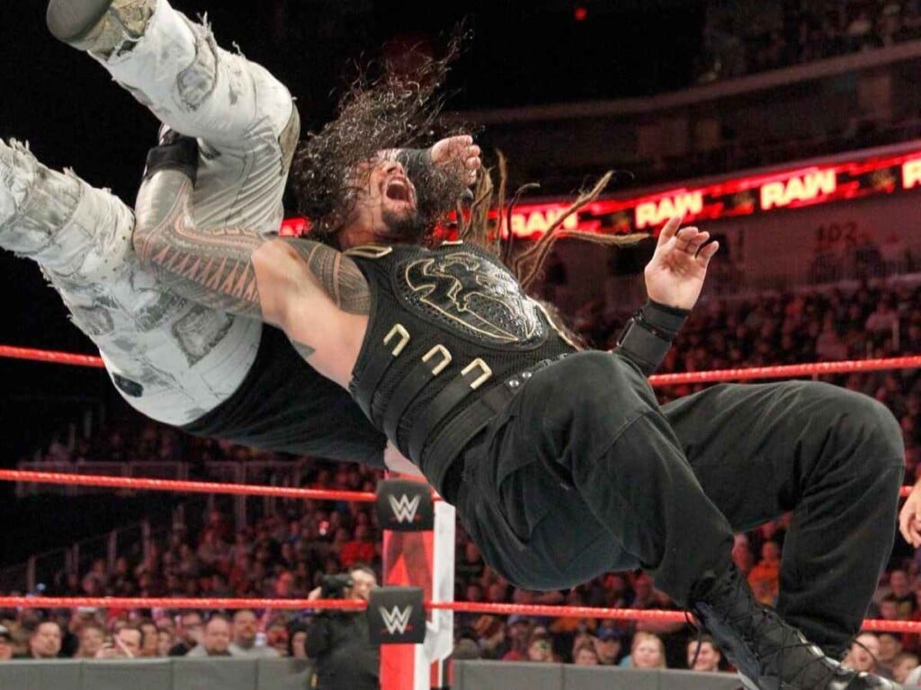 Roman Reigns hitting a Samoan Drop