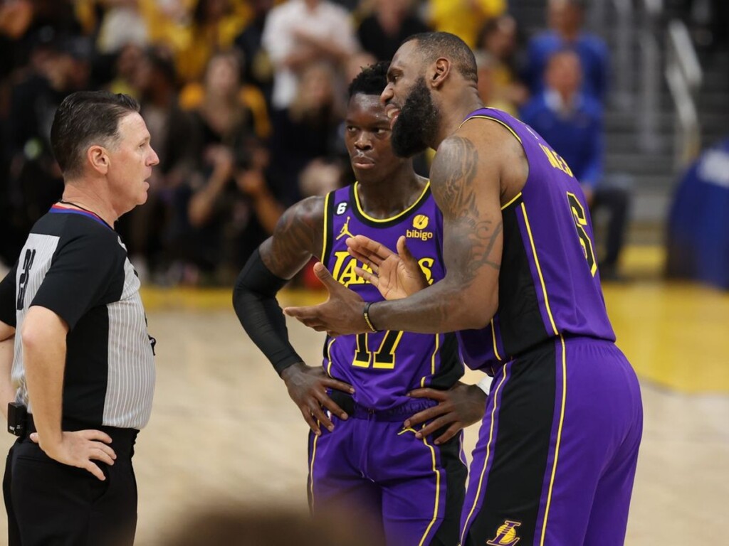 LeBron James and Dennis Schroder talking with an official