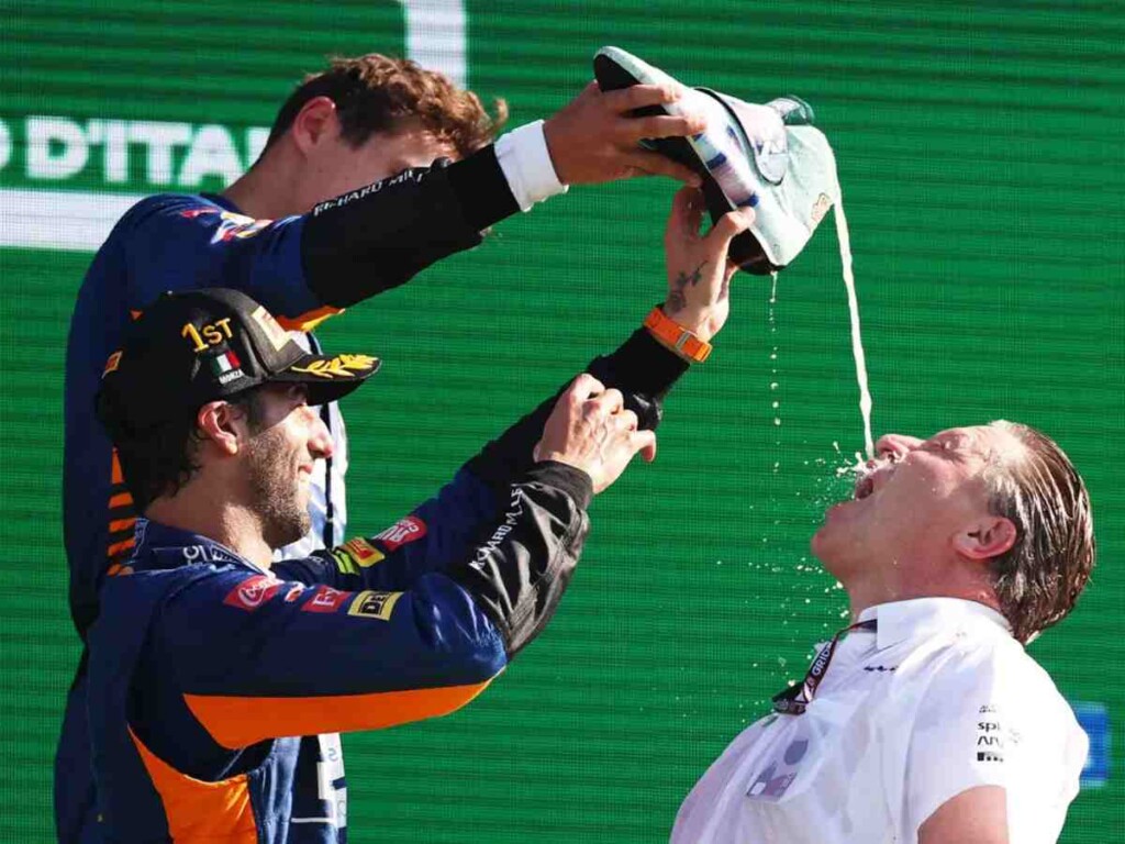 Daniel Ricciardo, Lando Norris and CEO Zak Brown, his last shoey