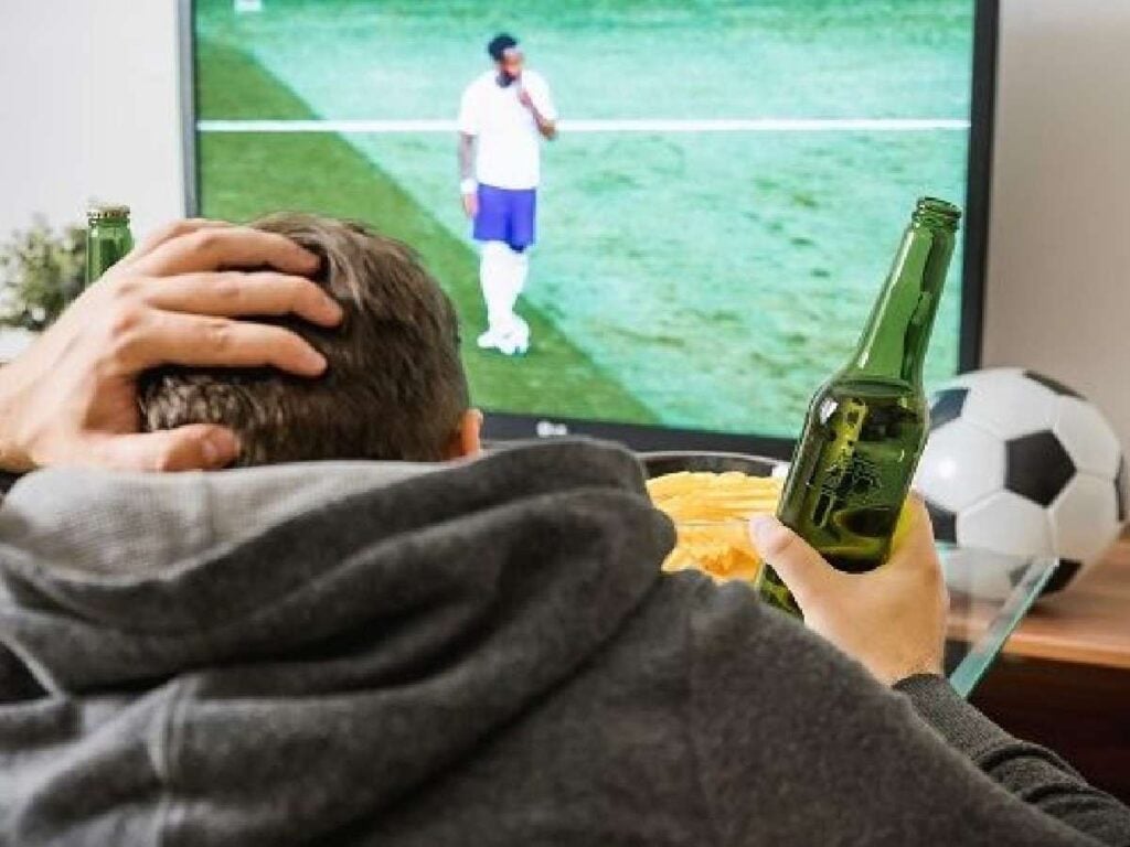 fan watching football on tv