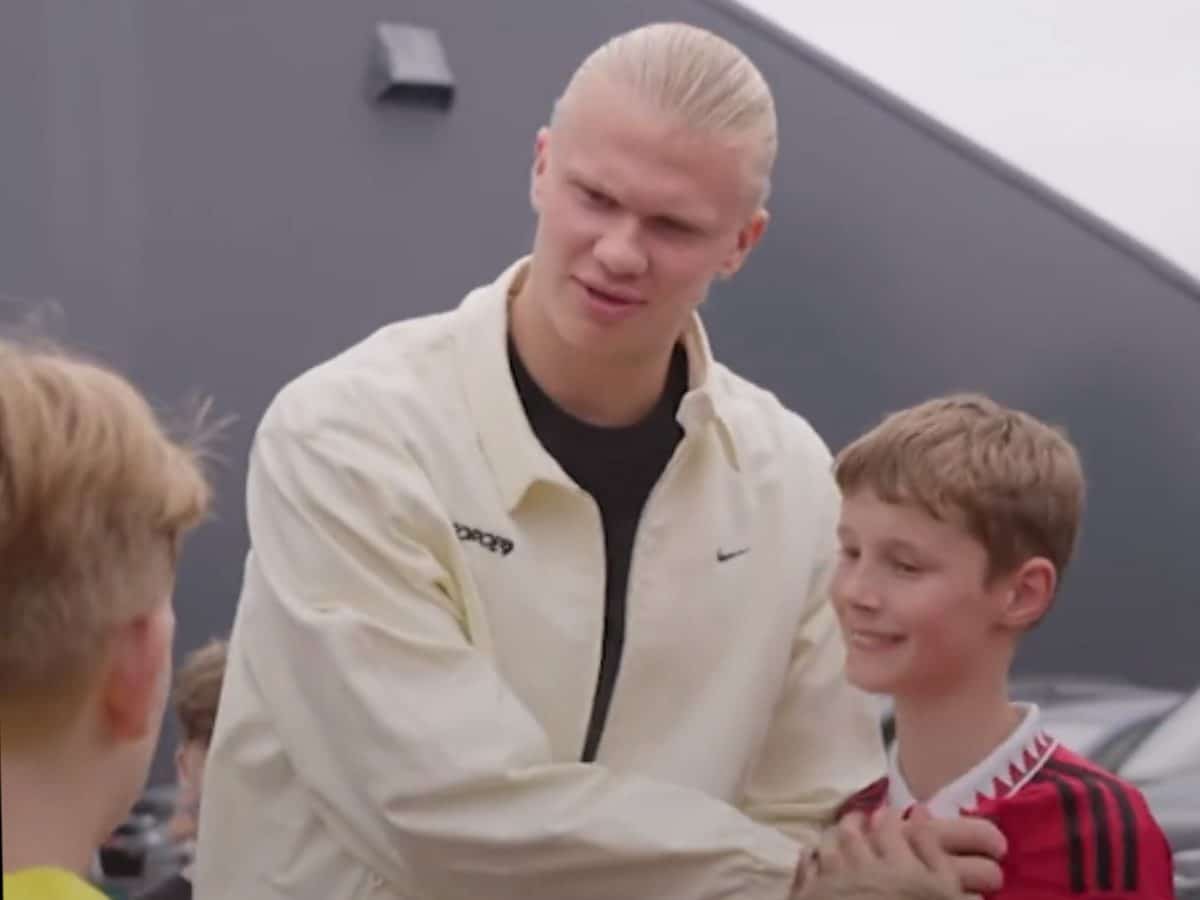 WATCH: Erling Haaland angrily covers Manchester United’s crest on a young fan’s jersey before taking a picture with him