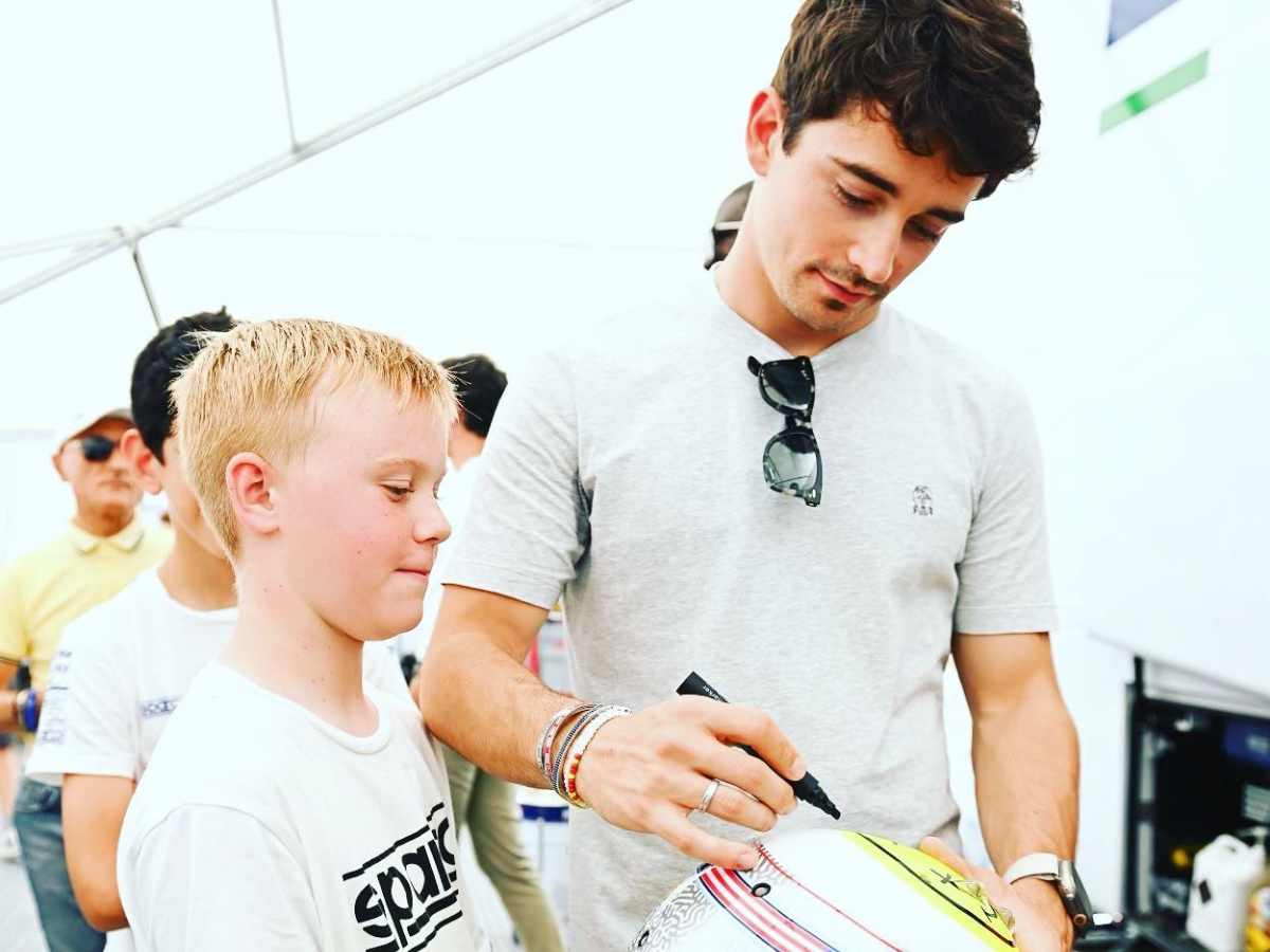 Kevin Harvick’s son is delighted as he gets his helmet autographed by Ferrari F1 driver Charles Leclerc 