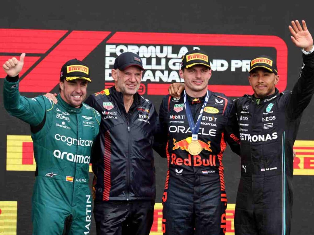 The 2023 Canadian GP podium, comprising of Fernando Alonso, Adrian Newey, Max Verstappen and Lewis Hamilton (image via GPFans)