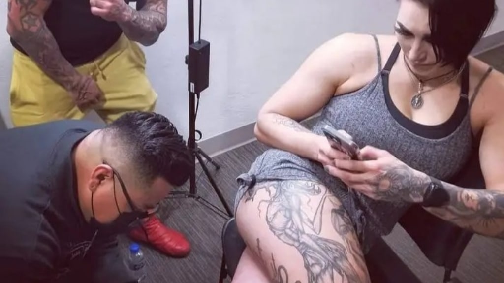 Rhea Ripley getting a tattoo 