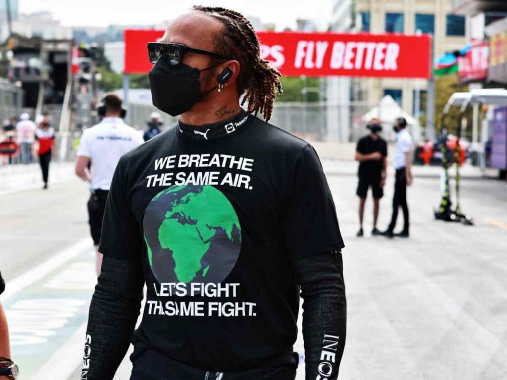 Lewis Hamilton wearing a shirt that reads about the environmental concerns