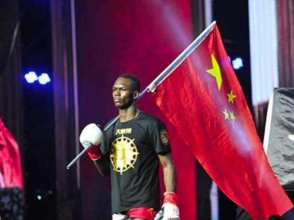 “Supports anyone who is paying him” – Fans blast Israel Adesanya after images of fighter representing China over Nigeria during kickboxing days resurface