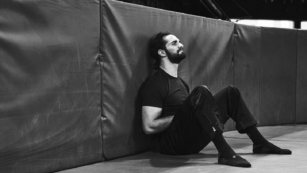 Seth Rollins sitting by the barricades