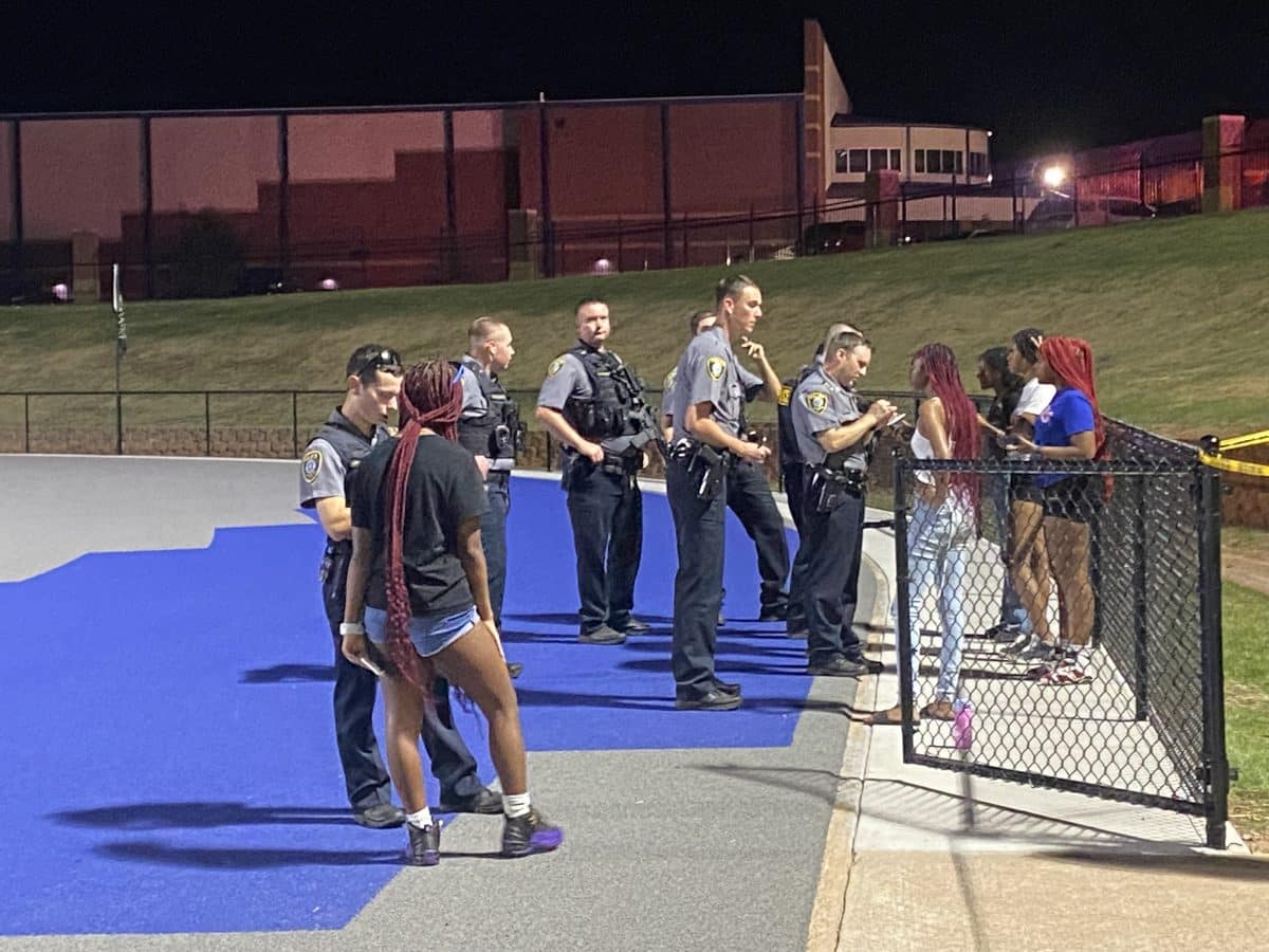 Authorities speak with students after a shooting a football game. Photo by Jeff Harrison