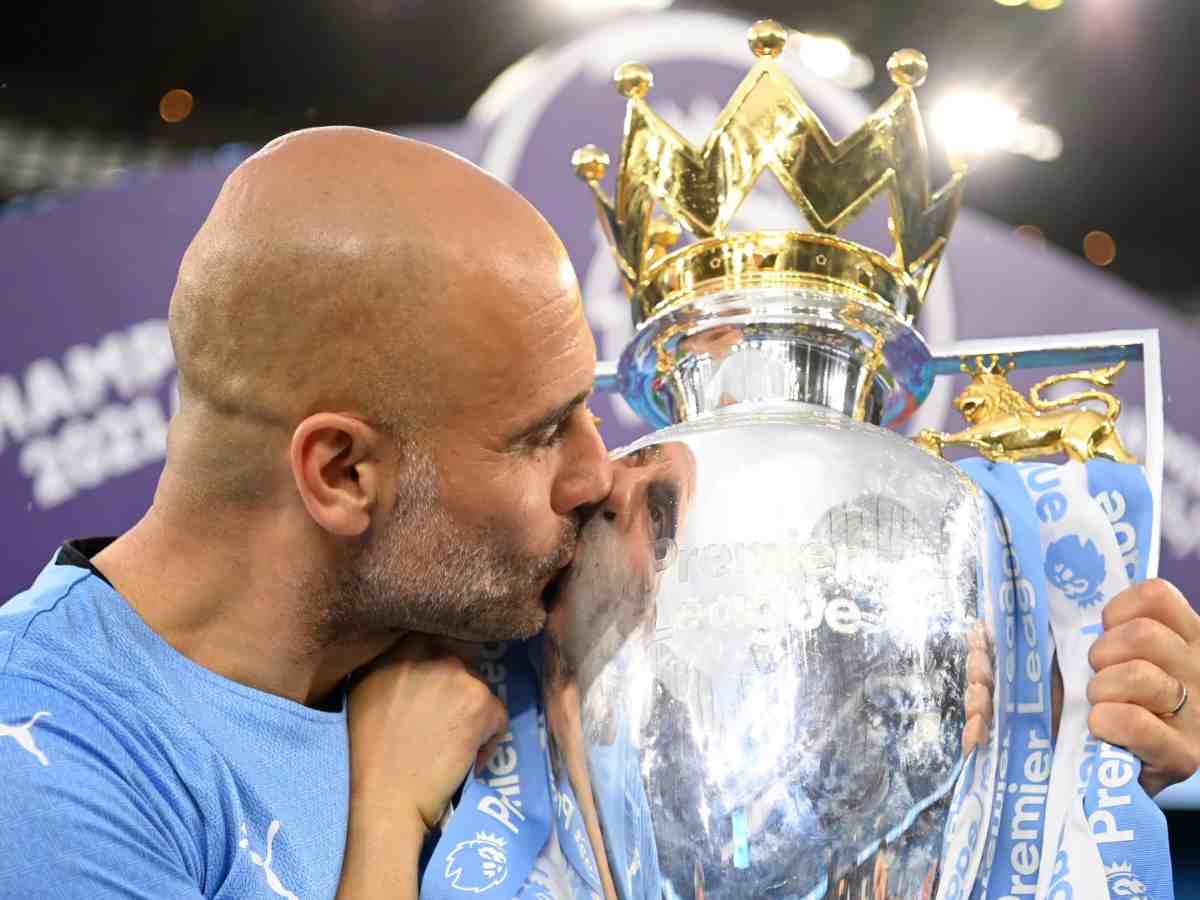 Guardiola kissing the Premier League title