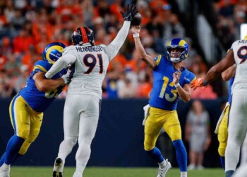Denver Broncos defensive end Matt Henningsen (91) deflects a pass from Los Angeles Rams quarterback Stetson Bennett (13) as guard Grant Miller (63) defends in the second quarter at Empower Field at Mile High