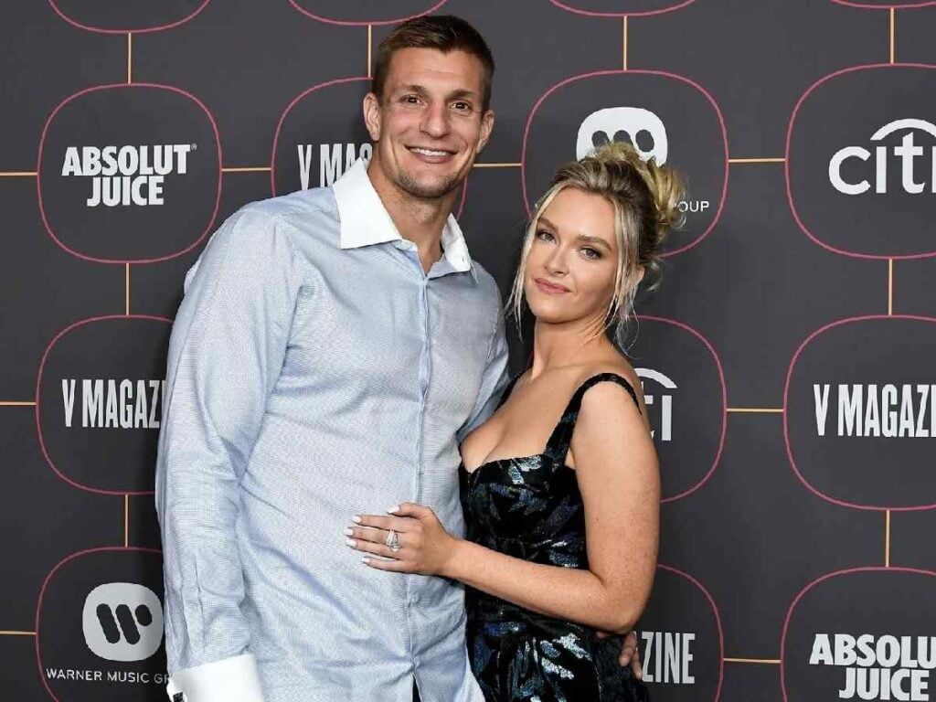 Rob Gronkowski’s ‘hot’ girlfriend Camille Kostek pushes him into the pool as the couple enjoy time off with their family
