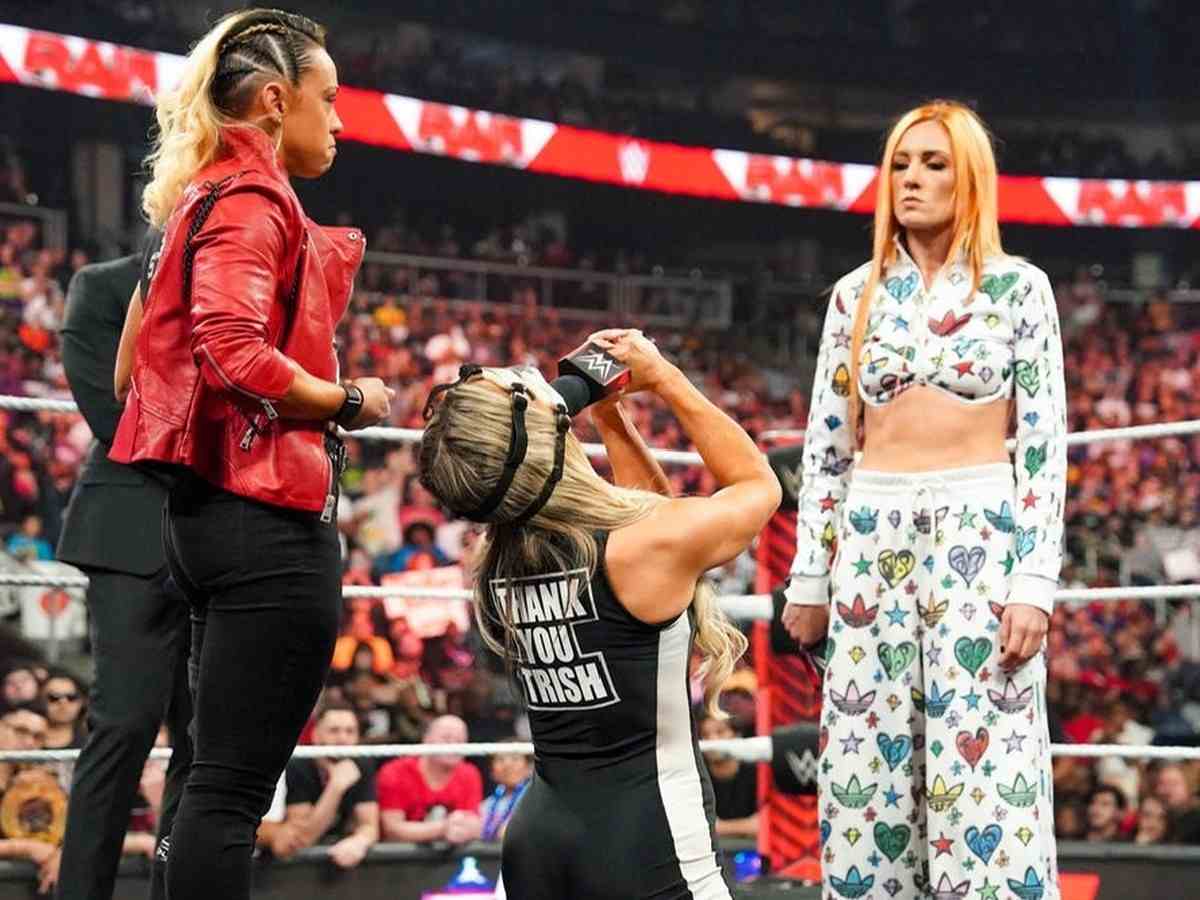 Becky Lynch looking down at Trish Stratus