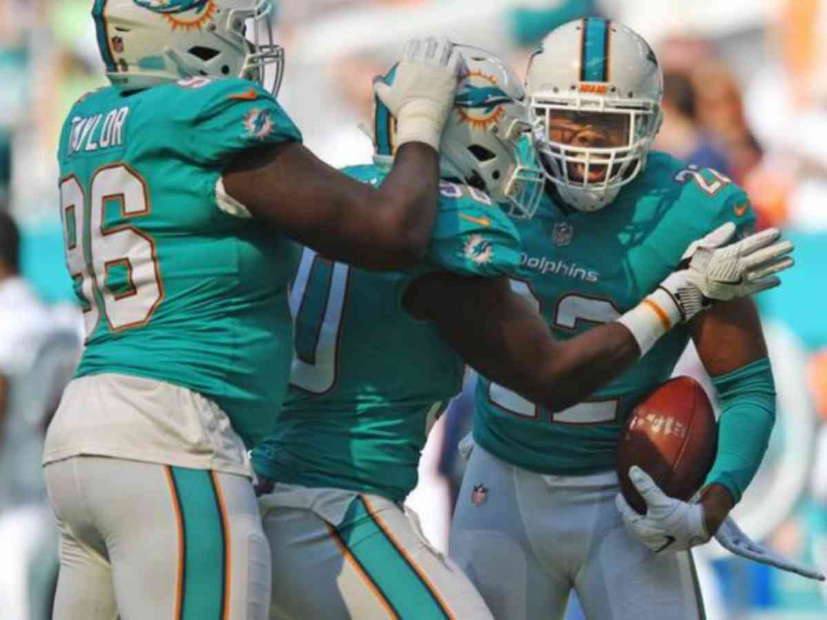 T.J. McDonald (22) celebrates an interception with teammates Charles Harris (90) and Vincent Taylor (96) against the Denver Broncos 