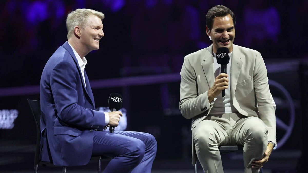 Jim Courier alongside Roger Federer