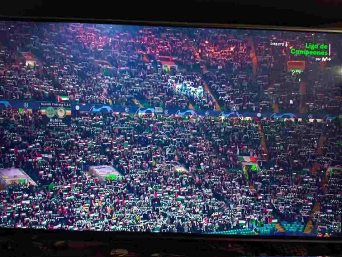 Celtic fans holding Palestine flags and banners to show their solidarity.