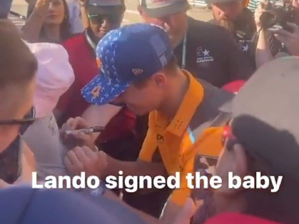 WATCH: Lando Norris signs on the back of a baby at Austin