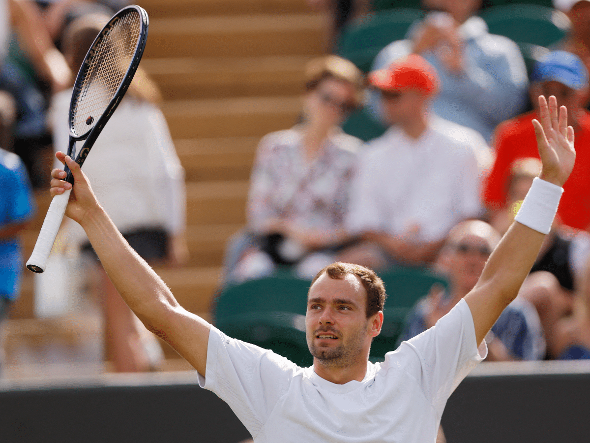 Russia's Roman Safiullin celebrates after winning his fourth round match 