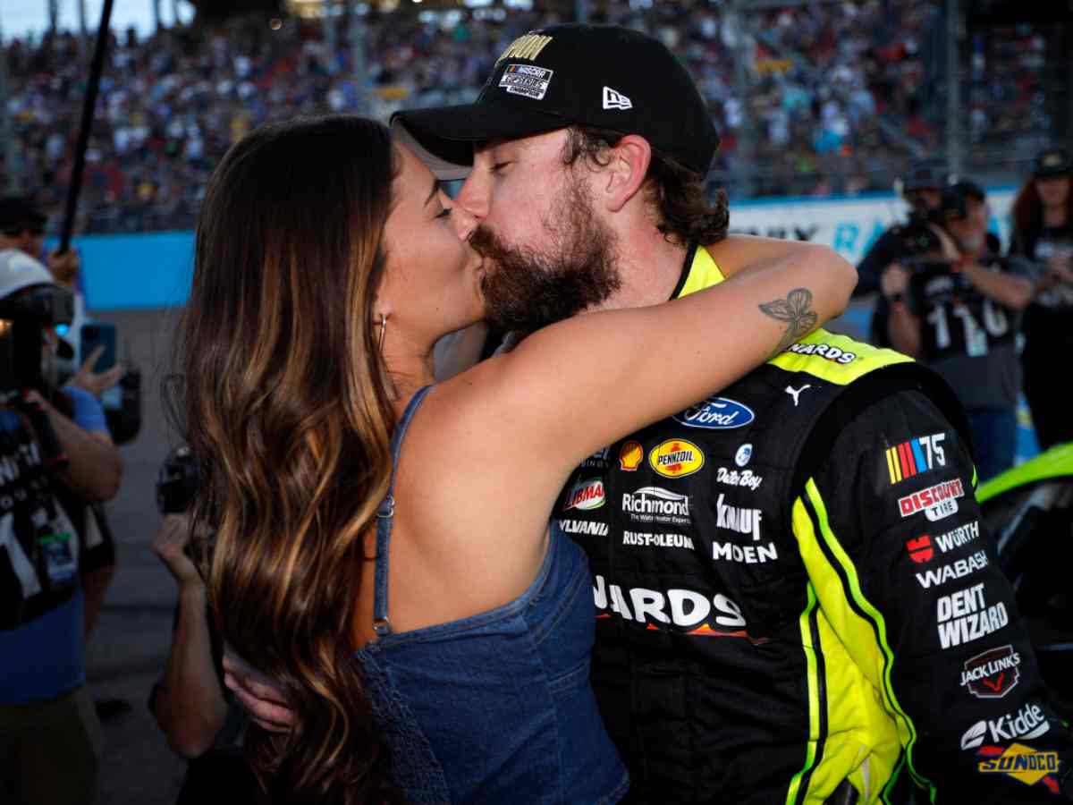 Ryan Blaney and Gianna Tulio share a kiss following a NASCAR race