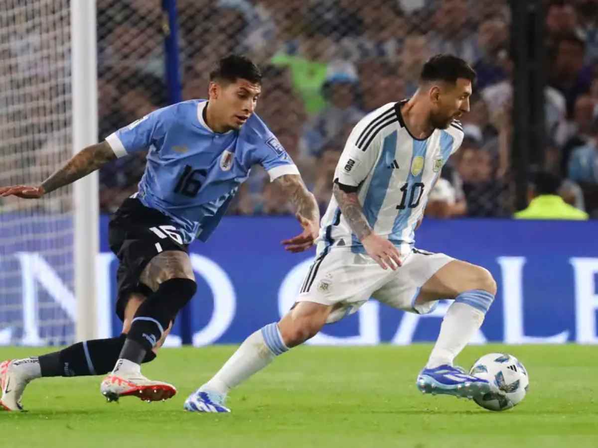 Mathias Olivera and Lionel Messi in action during the Uruguay vs Argentina World Cup Qualifier.