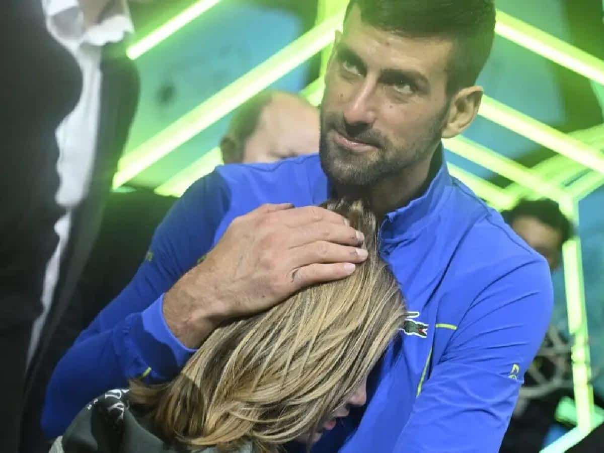 Novak Djokovic rescues little girl trapped among a rushing crowd following his Paris Masters victory over Grigor Dimitrov  