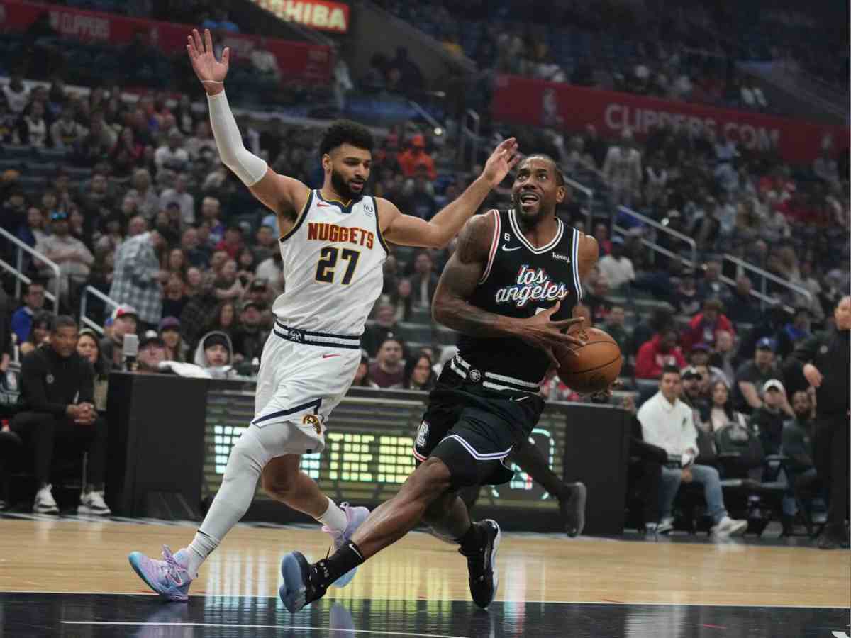 Kawhi Leonard drives past Denver Nuggets' guard Jamal Murray