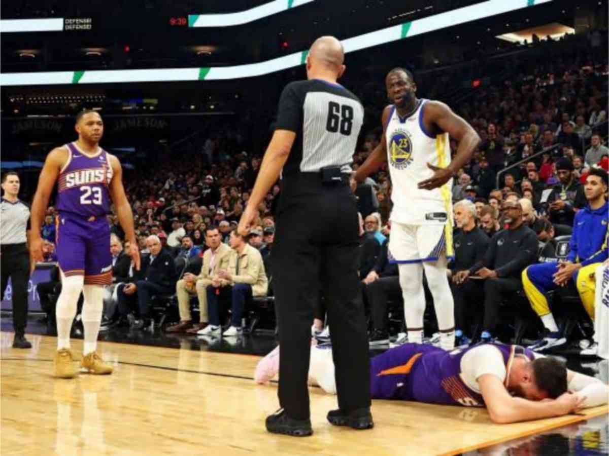 Jusuf Nurkic lies on the ground after Draymond Green hits him in the head 