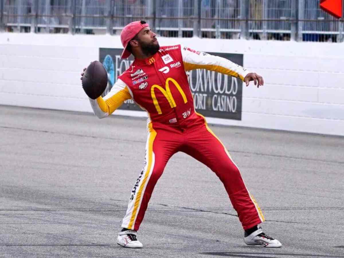 Bubba Wallace throwing a football