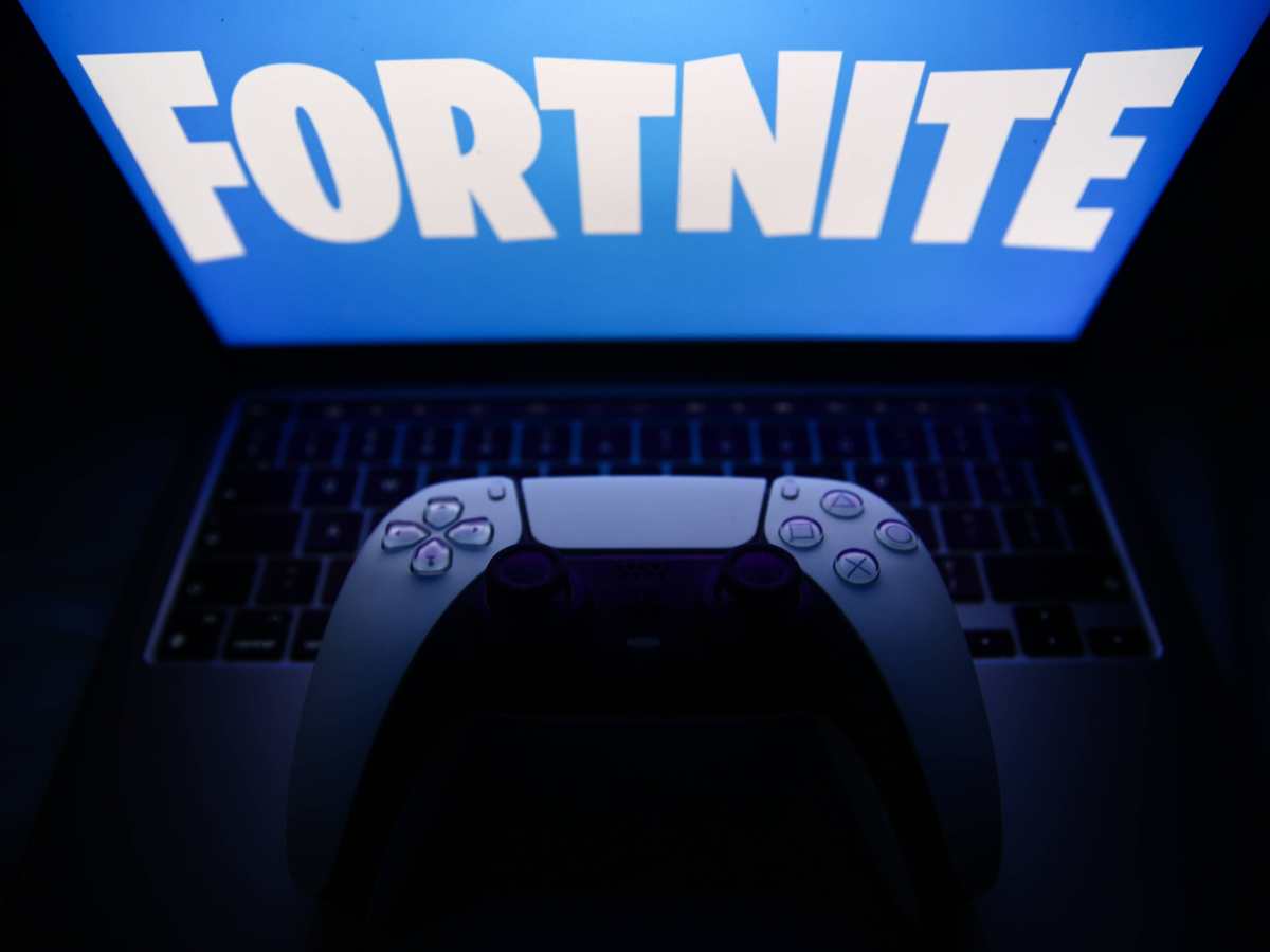 Lego Fortnite Photo Illustrations Fortnite logo displayed on a laptop screen and DualSense controller are seen in this illustration photo taken in Krakow, Poland on December 8, 2023. 