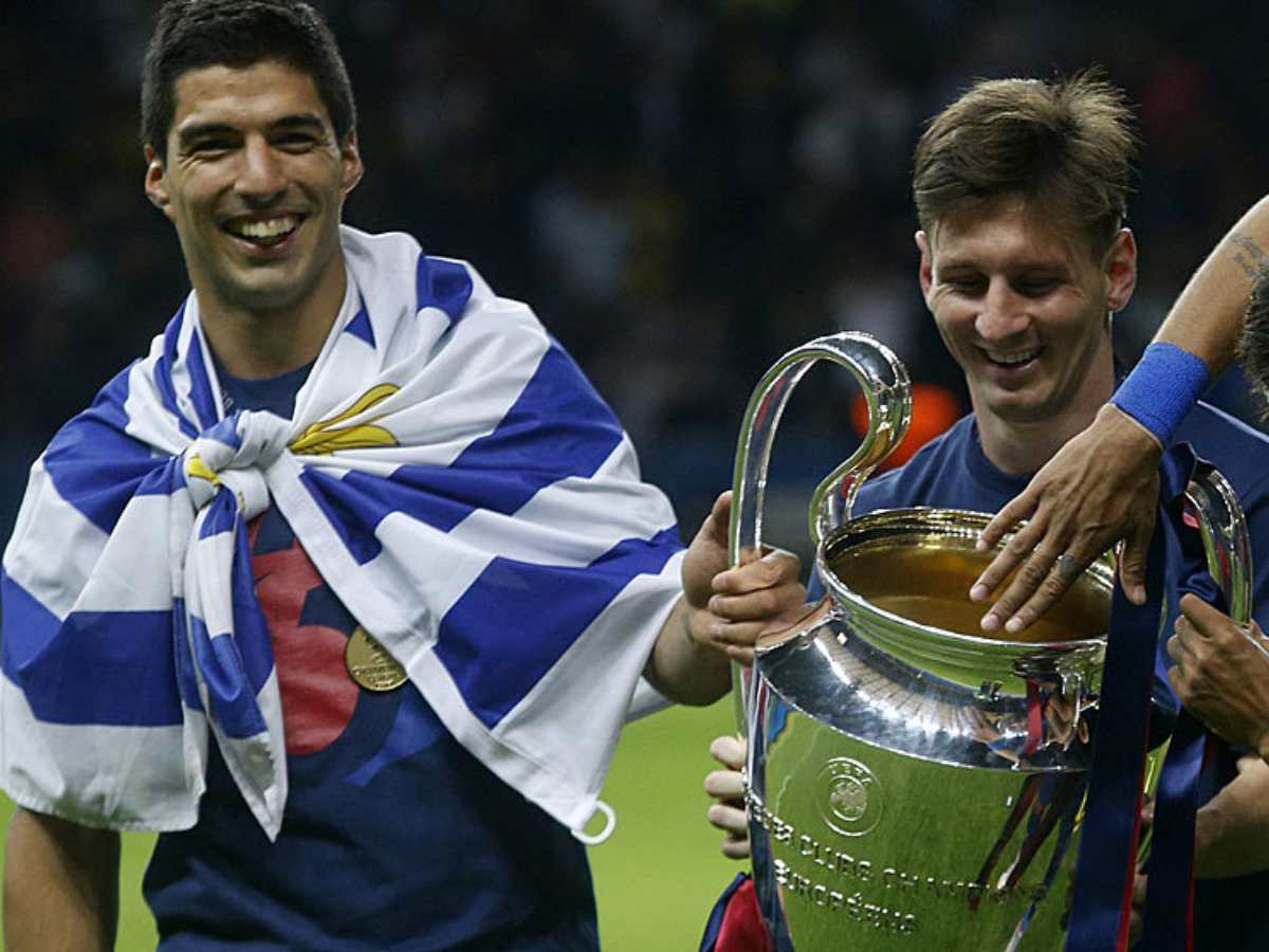 Luis Suarez and Lionel Messi with their Champions League title