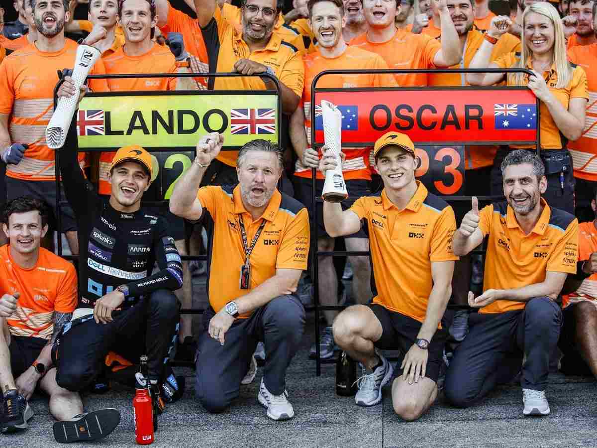 McLaren squad involving Lando Norris, Zak Brown, Oscar Piastri and Andrea Stella.