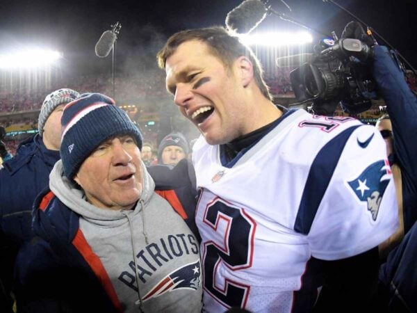 Bill Belichick and quarterback Tom Brady celebrate the win over the Kansas City Chiefs during overtime in the AFC Championship game at Arrowhead Stadium