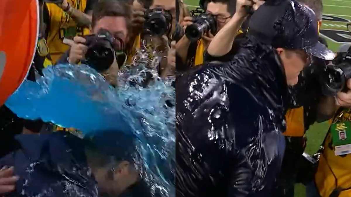 WATCH: Jim Harbaugh, who tried to escape initially, falls prey to the Gatorade bath following Michigan’s National Championship win