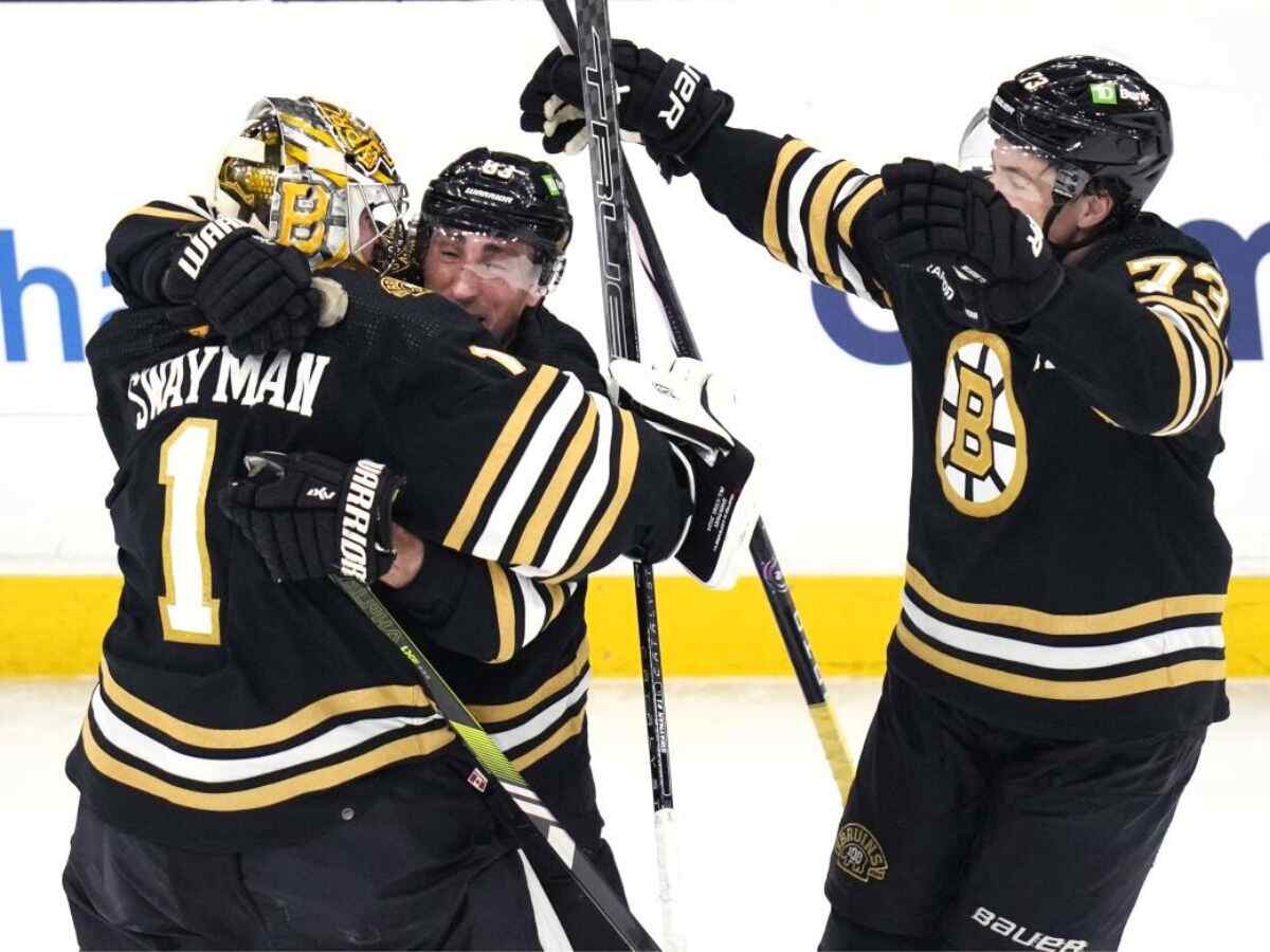 Jeremy Swayman, Brad Marchand and Charlie McAvoy