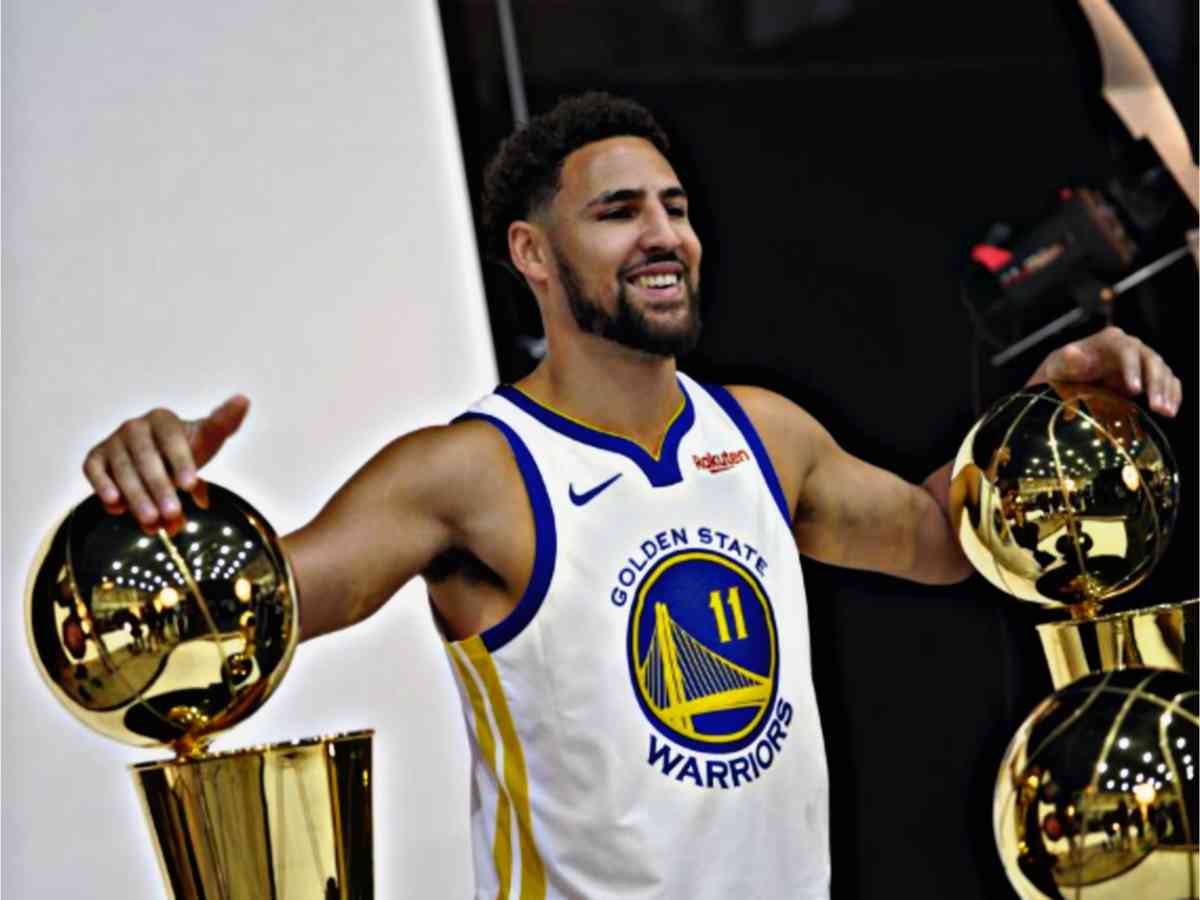 Klay Thompson during a photoshoot with the Warriors' NBA Championship trophies