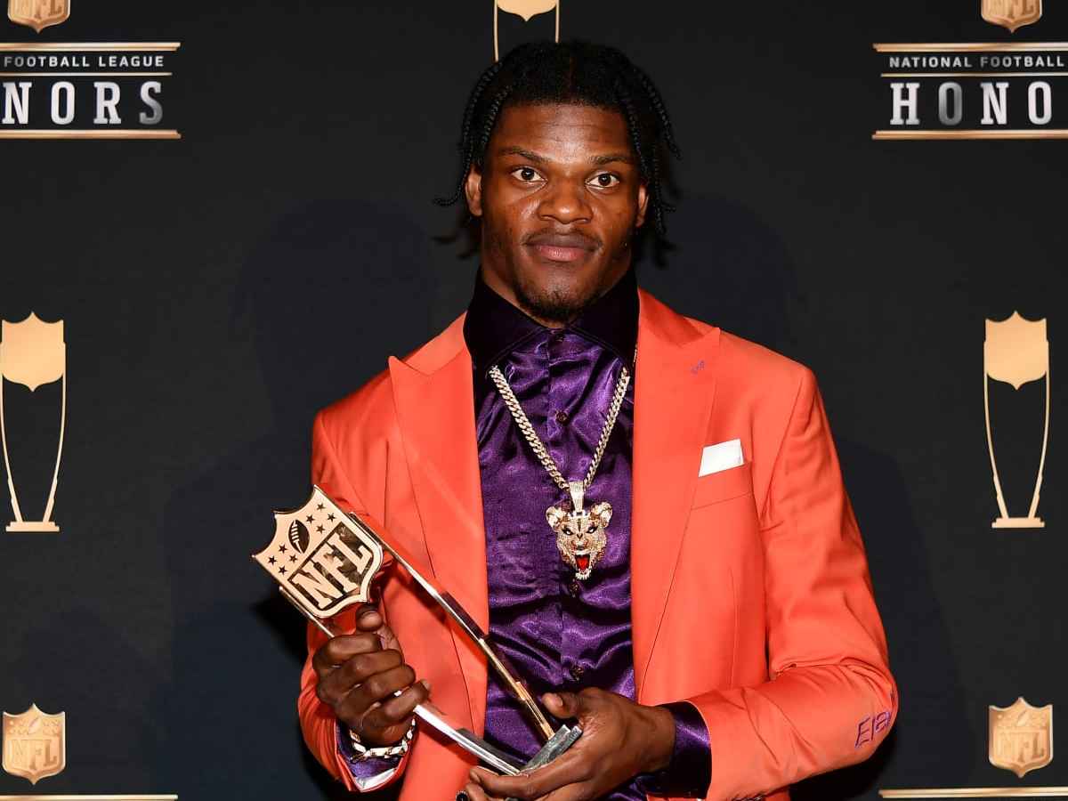 Lamar Jackson holding the NFL MVP trophy