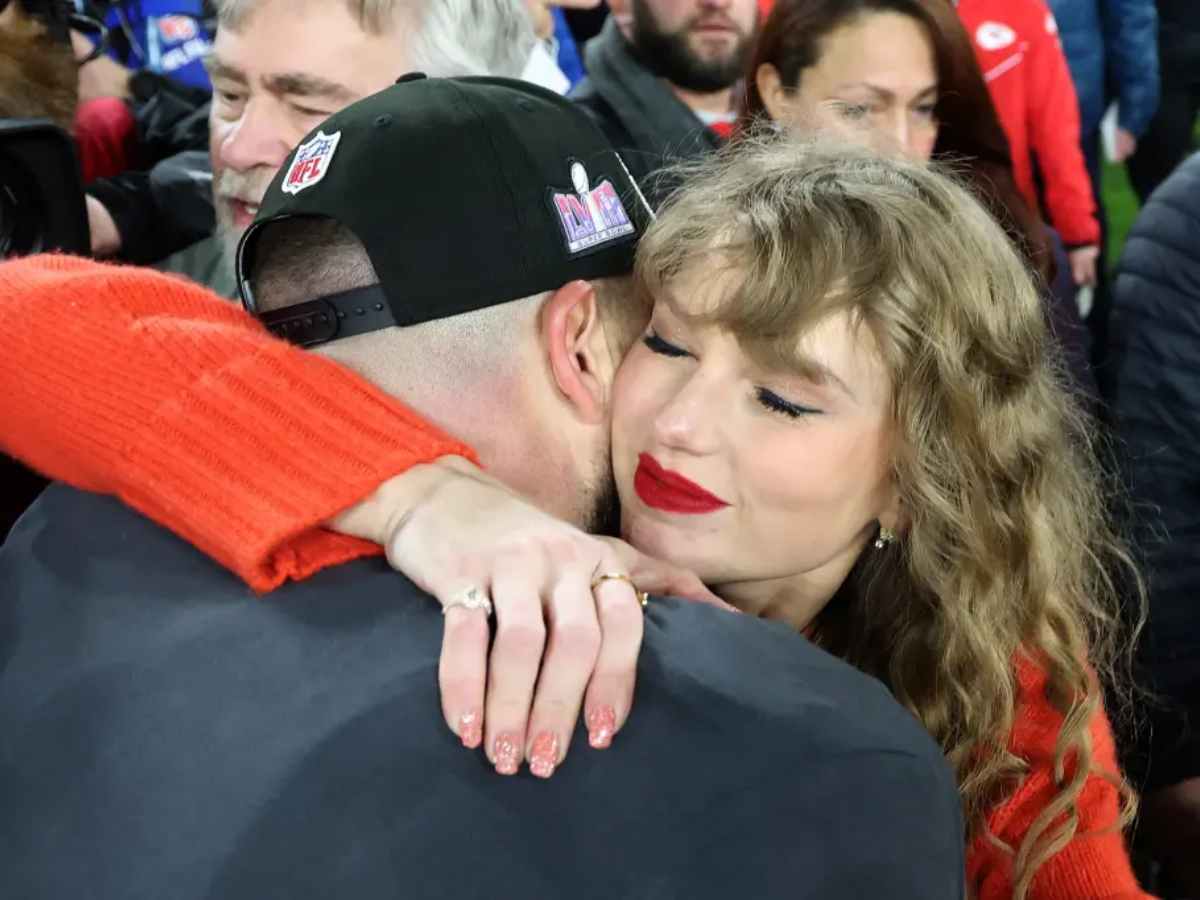 Taylor Swift hugging Travis Kelce after his AFC title victory