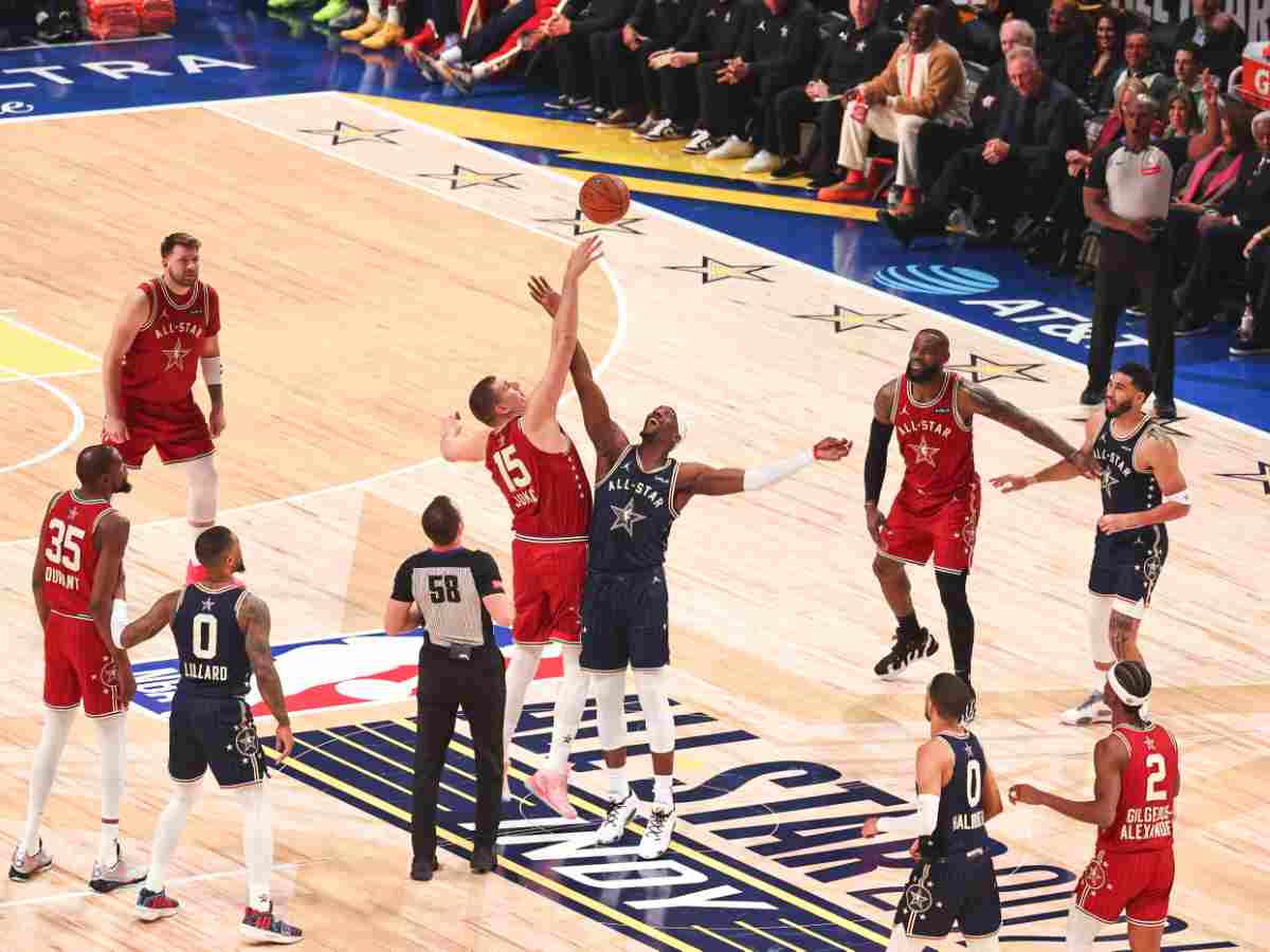 Western Conference s Nikola Jokic (C-L) of the Denver Nuggets and Eastern Conference s Bam Adebayo (C-R) of the Miami Heat tip off the game during the NBA, Basketball Herren, USA All-Star 2024 Game in Indianapolis