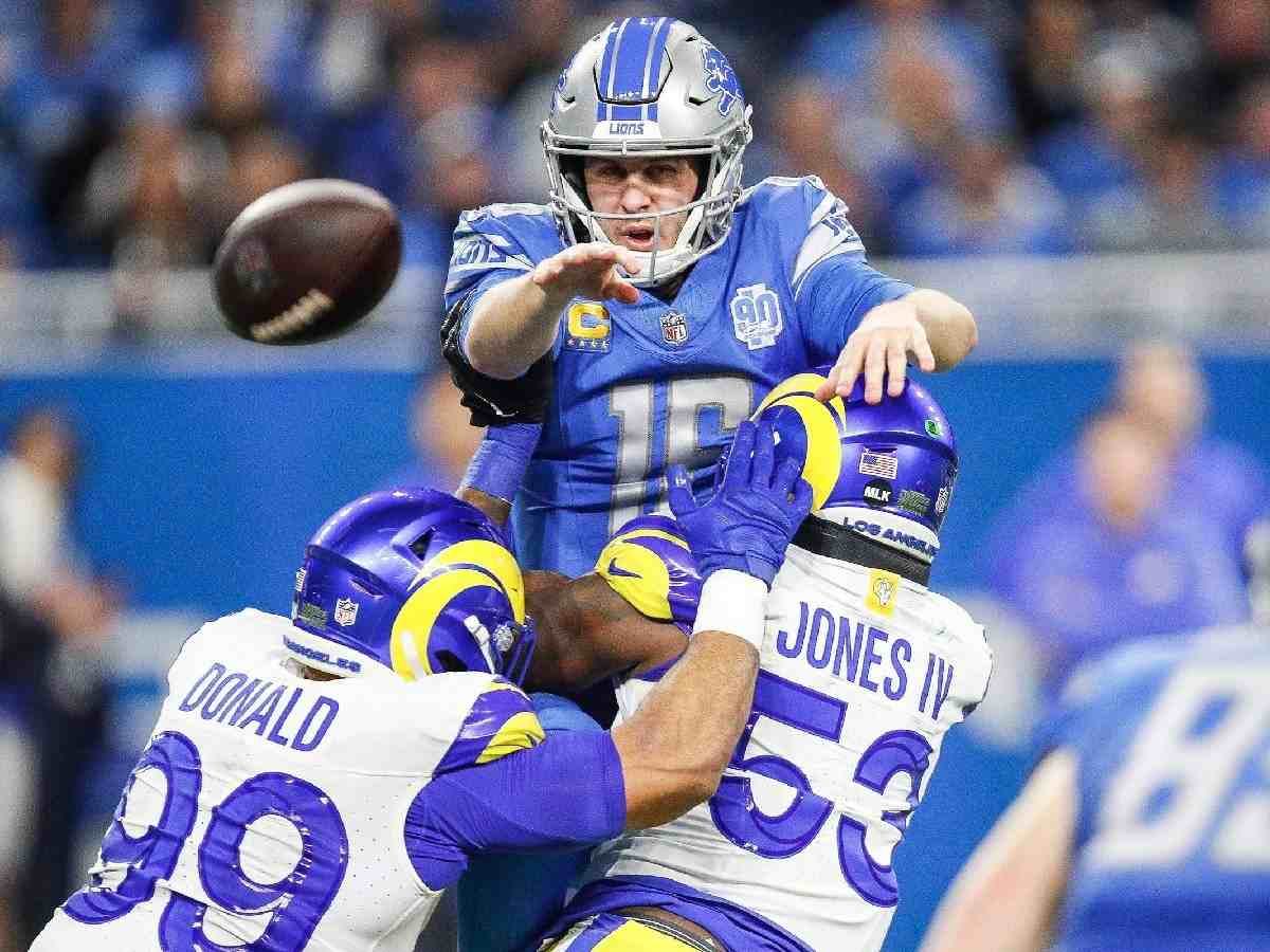 Detroit Lions quarterback Jared Goff makes a pass to tight end Brock Wright against Los Angeles Rams defensive tackle Aaron Donald and linebacker Ernest Jones during the first half of the NFC wild-card game at Ford Field 