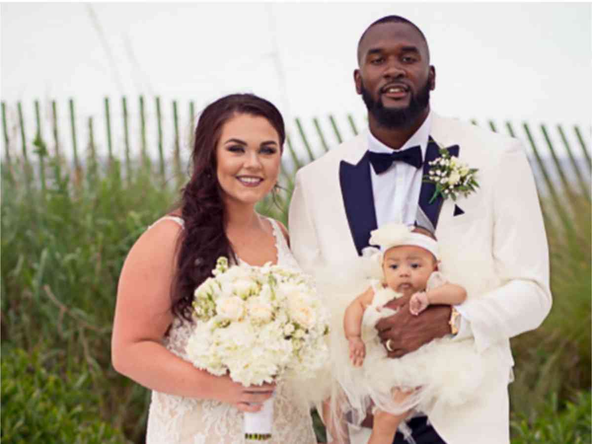 Kayla and Shaquille with Mia in their wedding ceremony