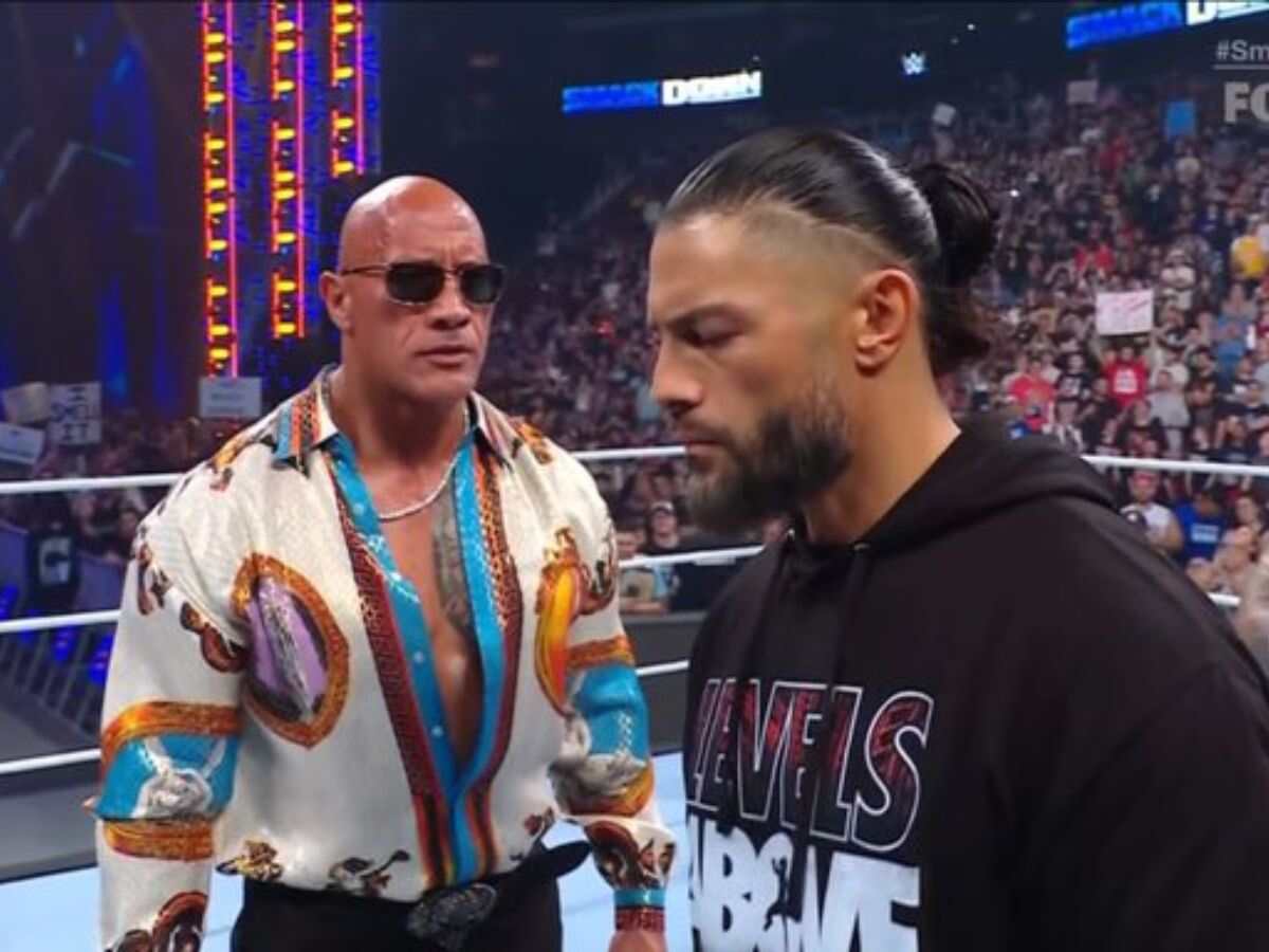 The Rock staring at Roman Reigns